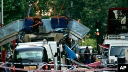 FILE - A double-decker bus blown up by a bomb and damaged cars are scattered at Tavistock Square in London, July 7, 2005. A mixture of homegrown extremists, geography and weak counterterrorism strategies have made Europe a prime target for jihadists.