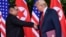 U.S. President Donald Trump and North Korea's leader Kim Jong Un shake hands during the signing of a document after their summit at the Capella Hotel on Sentosa island in Singapore, June 12, 2018. 