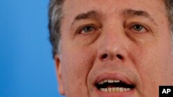 FILE - Argentina's Treasury Minister Nicolas Dujovne speaks during a press conference at Quinta de Olivos, in greater Buenos Aires, Argentina, April 17, 2019. Dujovne announced Aug. 17 that he was quitting his post.