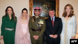 FILE - Jordan's King Abdullah (2nd R), Queen Noor (R), and Queen Rania (L) posing for a picture with Prince Hamza, and his new wife Princess Basma Otoum during their Muslim wedding ceremony in Amman. (AFP Photo/PETRA /Yousef Allan)