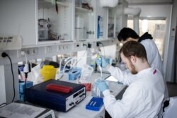 Researchers work on a vaccin against the new coronavirus at the Copenhagen's University research lab in Copenhagen, Denmark.