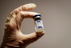 A medical specialist holds a vial of Sputnik V vaccine against the coronavirus in a department store in Moscow, Russia, Feb. 2, 2021.