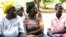 Four women in Uganda sitting on the ground. The women are part of a treatment group for Obstetric Fistula.