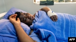 FILE - Activist Joana Mamombe lies hospitalized in Harare on May 15, 2020. after allegedly being abducted and beaten by police and eventually dumped along the roadside some distance from the capital.