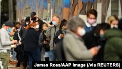 Orang-orang antre untuk tes COVID-19 di sebuah fasilitas tes di Melbourne seiring dengan merebaknya klaster kasus-kasus baru, Rabu, 26 Mei 2021. (Foto: James Ross/AAP Image via Reuters)