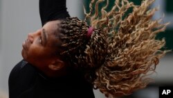 Serena Williams of the U.S. plays a shot against Kristie Ahn of the U.S. in the first round match of the French Open tennis tournament at the Roland Garros stadium in Paris, France, Monday, Sept. 28, 2020. 