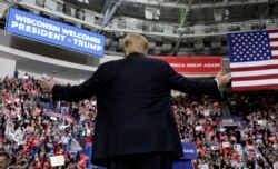 FILE - U.S. President Donald Trump reacts at a campaign rally at the Resch Center Complex in Green Bay, Wis., April 27, 2019.