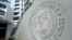 FILE - The International Monetary Fund logo is seen inside its headquarters in Washington.