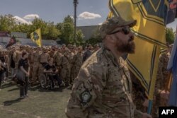 Members of the Azov Brigade attend the funeral of their late comrade Nazary Gryntsevych, a Ukrainian soldier who was killed on the battlefield, in Vinnytsia on May 10, 2024, amid the Russian invasion of Ukraine.