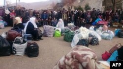 Syrians wait for the arrival of an aid convoy on Jan. 11, 2016 in the besieged town of Madaya as part of a landmark six-month deal reached in September for an end to hostilities in those areas in exchange for humanitarian assistance.