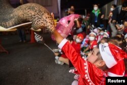 Elephants in Santa Claus costumes visit a school in Ayutthaya