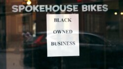 A sign in the window informs passersby that Spokehouse Bikes in the Upham's Corner neighborhood of Boston is a Black-owned business, June 24, 2020.