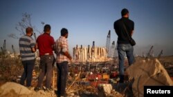 People view the damaged site of Tuesday's blast in Beirut's port area, Lebanon, Aug. 7, 2020. 