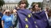 People hold flags during a 'March for Europe' demonstration against Britain's decision to leave the European Union, in central London, Britain, July 2, 2016. 