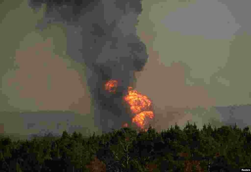 Des flammes sortent de la forêt après l'explosion d'un oléoduc, le 31 octobre 2016, à Helena, Alabama.