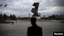 FILE - A soldier stands guard at the doors of the War Museum visited by foreign reporters during a government-organized tour in Pyongyang, North Korea, Oct. 9, 2015.