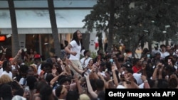 People enjoy themselves along Ocean Drive on March 19, 2021, in Miami Beach, Florida.