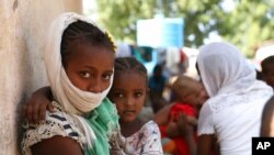 Refugees from the Tigray region of Ethiopia wait to register at the UNCHR center at Hamdayet, Sudan, Nov. 14, 2020. Ethiopia’s defiant Tigray regional government has fired rockets at two airports in the neighboring Amhara region.