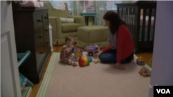 FILE - A mother and her child have play time together.