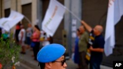 A U.N. peacekeeper stands guard during a protest calling to the rival leaders of the two communities for peace in the Cyprus island, at Ledras main crossing point inside the U.N buffer zone that divided the Greek and Turkish Cypriots controlled areas, Nicosia, Cyprus, June 30, 2017. 