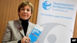 Edda Mueller, chairwoman of Transparency International Germany, stands for the media with the Corruption Perceptions Index 2018, before the presentation of the yearly report at a news conference in Berlin, Germany, Jan. 29, 2019.