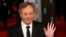 Director Ang Lee poses as he arrives for the British Academy of Film and Arts awards ceremony at the Royal Opera House in London, Feb. 10, 2013.