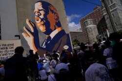 Demonstrators stop at the John Lewis Mural during a march for voting rights, Aug. 28, 2021, in Atlanta.