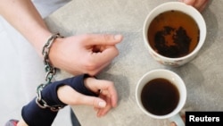 Alexandr Kudlay and Viktoria Pustovitova, tired of occasional break-ups, found an unusual solution to stay inseparable. On St. Valentine's Day, they decided to handcuff their hands together. (REUTERS/Gleb Garanich)