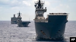 FILE - In this undated photo provided by the Australian Defense Force, Royal Australian Navy Ships Canberra, Supply and Warramunga sail in formation with 37 ships during Exercise Rim of the Pacific 2022.