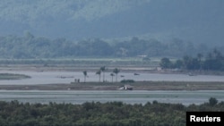 People are seen on Myanmar side, during ongoing conflict in Rakhine state of Myanmar, in Teknaf area of Cox's Bazar, Bangladesh, June 24, 2024.