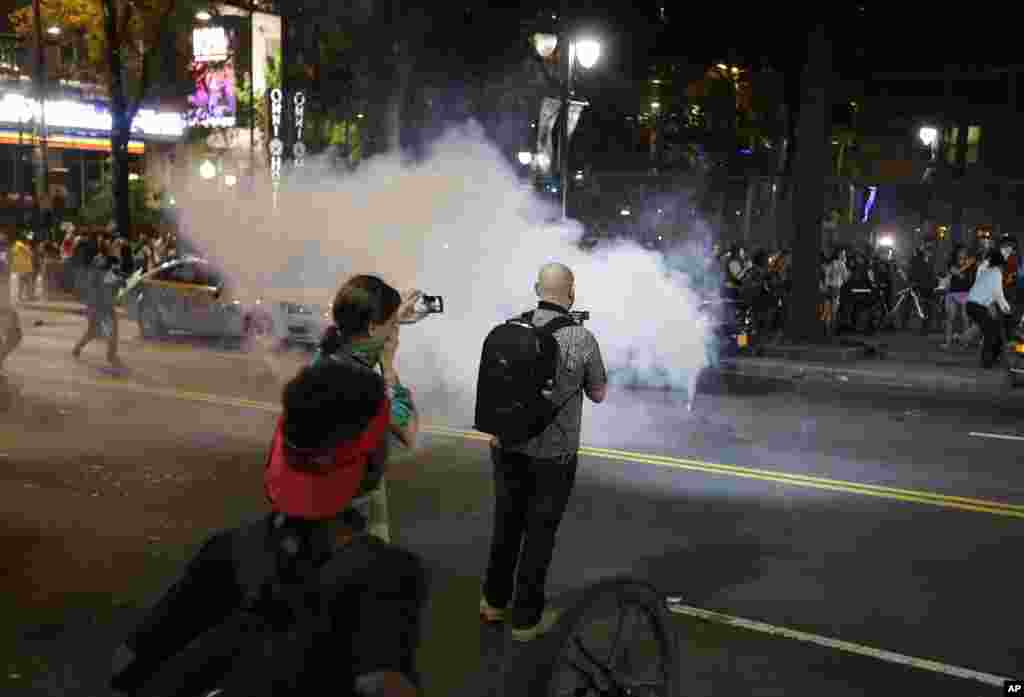 Demonstrators protest Tuesday's fatal police shooting of Keith Lamont Scott in Charlotte, N.C. on Sept. 21, 2016. Protesters rushed police in riot gear at a downtown Charlotte hotel.