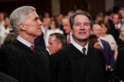 FILE - Supreme Court Associate Justices Neil Gorsuch, left, and Brett Kavanaugh watch as President Donald Trump arrives to give his State of the Union address to a joint session on Congress at the Capitol in Washington.