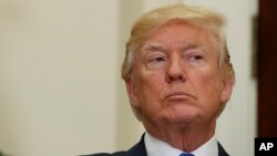 President Donald Trump listens in the Roosevelt Room of the White House in Washington, Aug. 2, 2017, during an event to unveil legislation that would place new limits on legal immigration. 