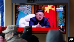 FILE - People watch a TV broadcast showing a news program reporting about North Korean leader Kim Jong Un with a file image if him, at the Seoul Railway Station in Seoul, South Korea, April 21, 2020. 