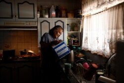 Barkindji elder Patricia Doyle uses boxed water to make a cup of tea at her home in Menindee, New South Wales, Australia, Sept. 29, 2019. At Menindee, residents blame the government for exacerbating the drought by draining the river in 2017.