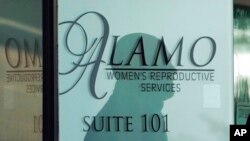 The shadow of a security guard is seen on the doorway to Alamo Women's Reproductive Services, Oct. 7, 2021, in San Antonio, Texas. 