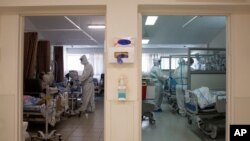 Medical professionals treat patients in the coronavirus ward at Barzilai Medical Center in Ashkelon, Israel, Aug. 26, 2021. 