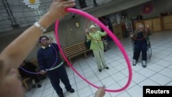 Patients with Alzheimer's and dementia during a therapy session inside the Alzheimer foundation in Mexico City, FILE April 19, 2012. 