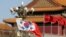 FILE - South Korea's and China's flags flutter next to Tiananmen Gate during the visit of then-South Korean President Moon Jae-in in Beijing, Dec. 15, 2017. 