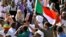 Sudanese demonstrators celebrate after Defense Minister Awad Ibn Auf stepped down as head of the country's transitional ruling military council, as protesters demanded quicker political change, near the Defense Ministry in Khartoum, Sudan, April 13, 2019.