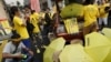 FILE - People sell umbrellas to supporters of pro-democracy group "Bersih" (Clean) near Dataran Merdeka in Malaysia's capital city of Kuala Lumpur, Aug. 30, 2015.