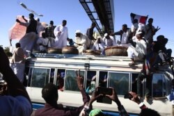 Sudanese protesters rally in front of a court in Omdurman near the capital Khartoum, Dec. 30, 2019, during the trial of intelligence agents for the death of teacher Ahmed Al-Khair while in custody of intelligence services.