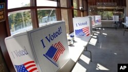 An early election ballot completion area is being prepared at a collection location at the North Park Ice Skating Rink Lodge area, Oct. 9, 2020, in McCandless, Pa. 