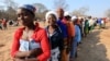 FILE: Women queue for food assistance distributed by the United Nations World Food Programme in Mwenezi, about 450 kilometers (280 miles) south of Harare, Zimbabwe, Wednesday, Sept. 9 2015. 