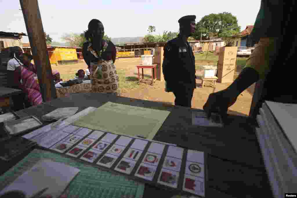 A man registers to vote at a polling station in Kibi, eastern Ghana, December 7, 2012. 
