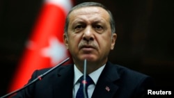 FILE - President Erdogan addresses members of parliament from his ruling AK Party (AKP) at the Turkish parliament in Ankara.