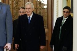 Senate Majority Leader Mitch McConnell, R-Ky., walks past the entrance to the Senate chamber as the arrives at his office at the Capitol, Jan. 22, 2020.