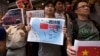 Anti-Vietnam protesters hold posters with slogans and a picture showing a map of the South China Sea including the Paracel Islands, during a protest defending China's territory claim and condemning Vietnam's anti-Chinese protests, in Hong Kong May 19, 201