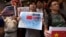 Anti-Vietnam protesters hold posters with slogans and a picture showing a map of the South China Sea including the Paracel Islands, during a protest defending China's territory claim and condemning Vietnam's anti-Chinese protests, in Hong Kong May 19, 201