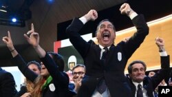 Mayor of Milan Giuseppe Sala and members of Milan-Cortina delegation celebrate after winning the bid to host the 2026 Winter Olympic Games. (Philippe Lopez/Pool via AP)
